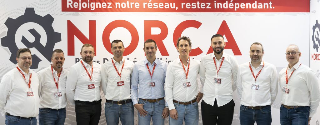 Equipe commercial au stand de la société NORCA au salon Solutrans 2025, espace d'accueil moderne pour les professionnels du transport.